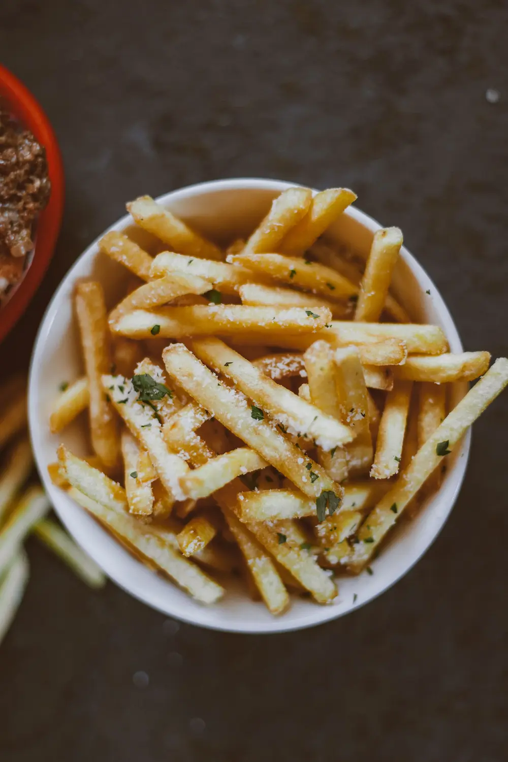 Bowl of fries with herbs from above