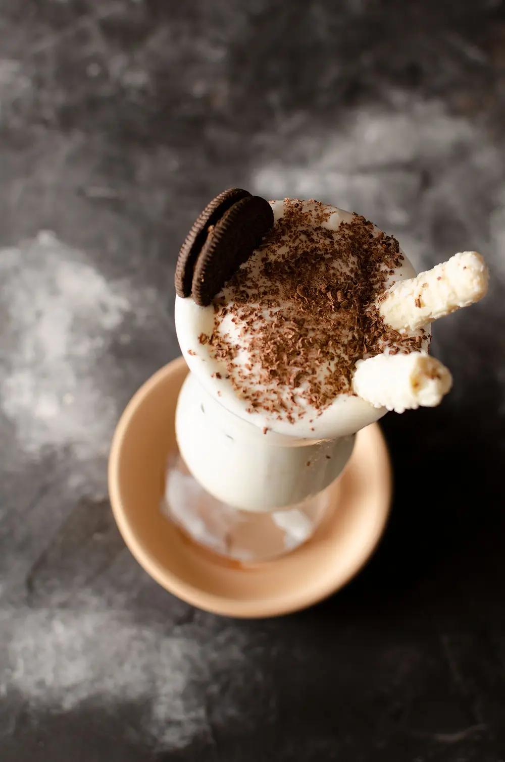 Cookies and cream milkshake topped with a cookie