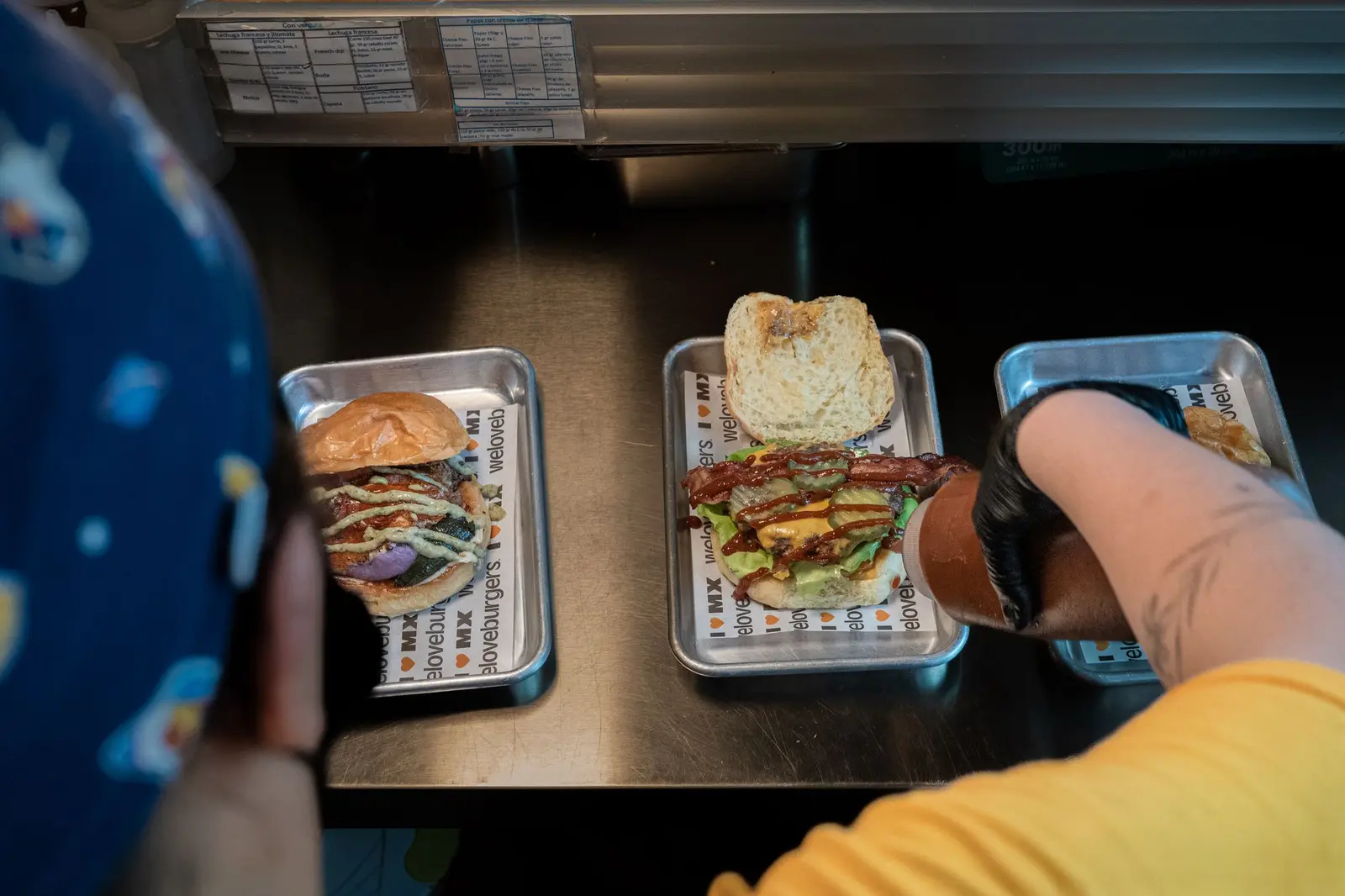 Burgers being assembled on metal trays